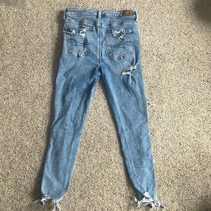These are high rise, ripped jeans from American Eagle. The color is light blue